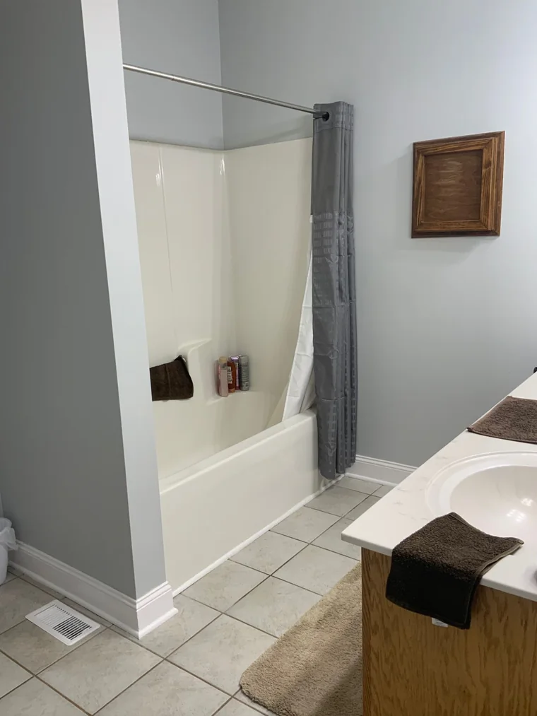Alcove tub with shower curtain before the conversion